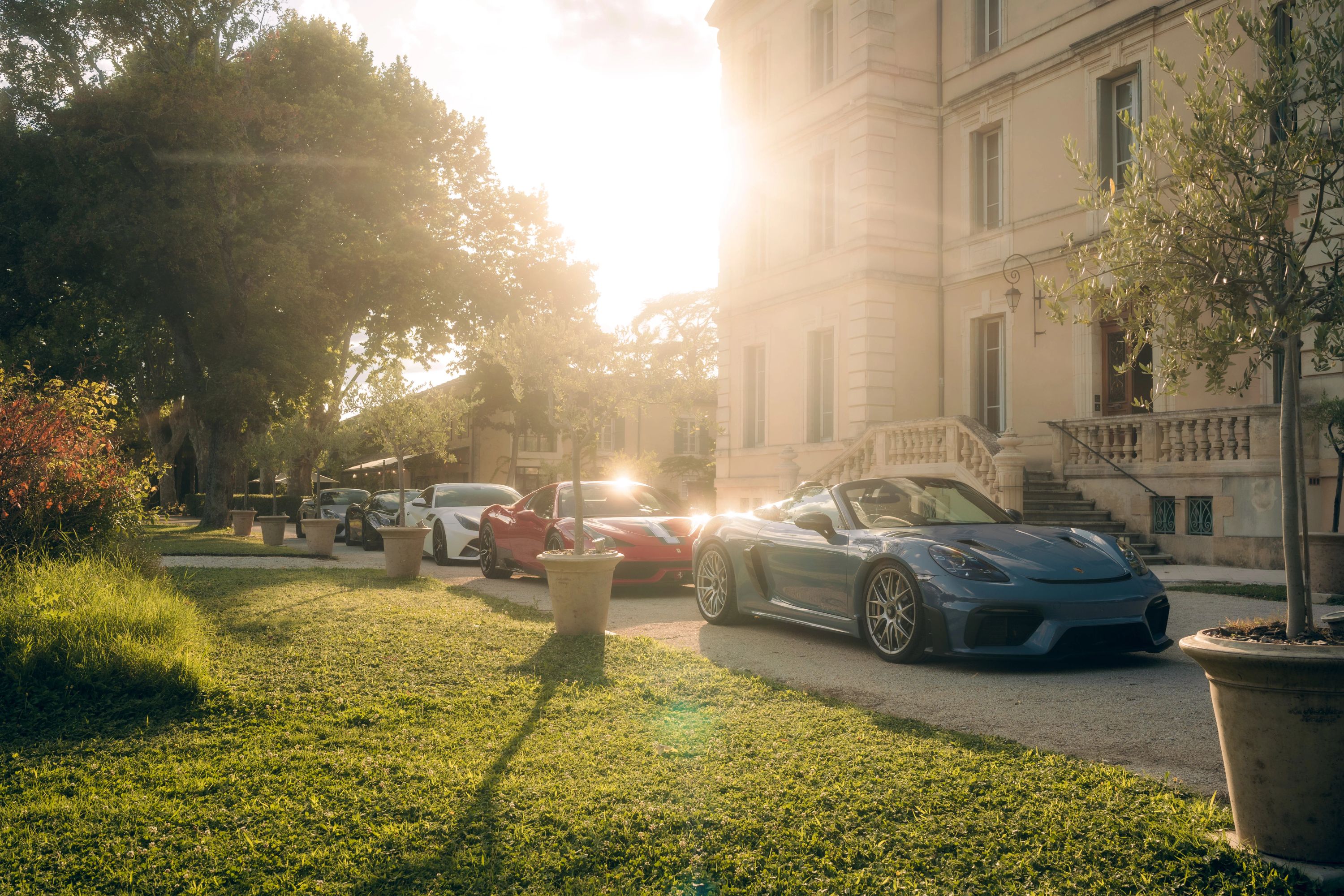 Luxury cars on a scenic road